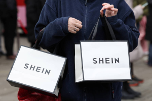Shopper carrying two SHEIN shopping bags
